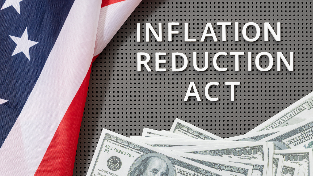 Inflation reduction Act law concept. Fat lay of text, american flag and dollar banknotes