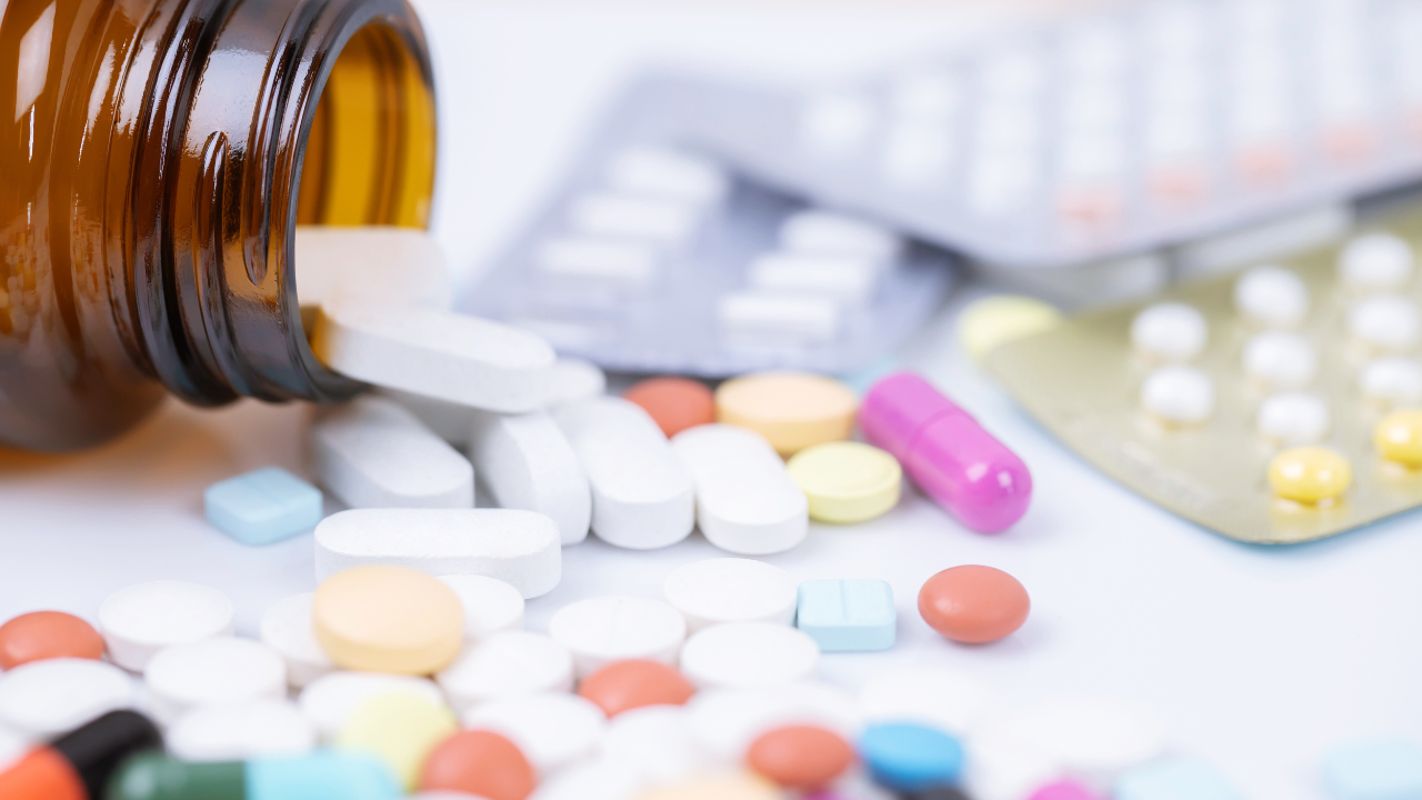 Pill bottle spilling out. colorful pills capsule on to surface tablets on a white background. drug medical healthcare pharmacy concept. pharmaceuticals antibiotics pills medicine in blister packs. Image Credit: Adobe Stock Images/methaphum