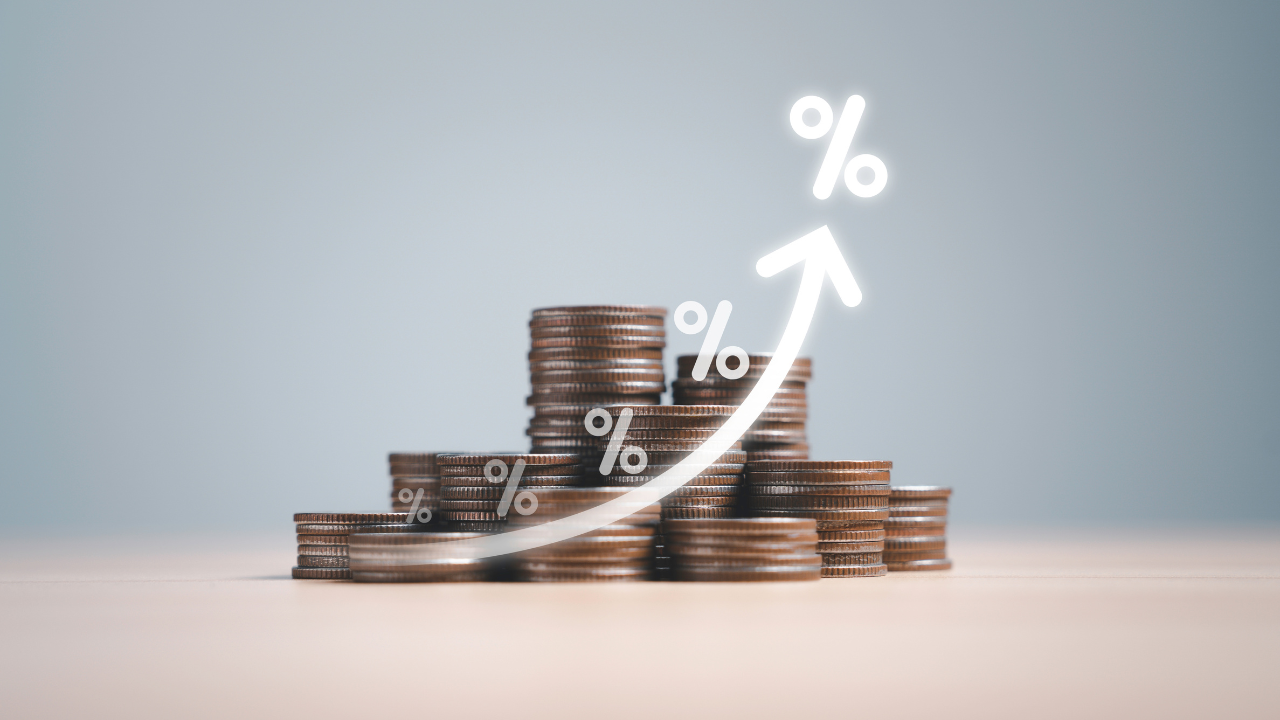 Coins money stacking with up arrow and percentage symbol for financial banking increase interest rate or mortgage investment dividend from business growth concept. Image Credit: Adobe Stock Images/Dilok