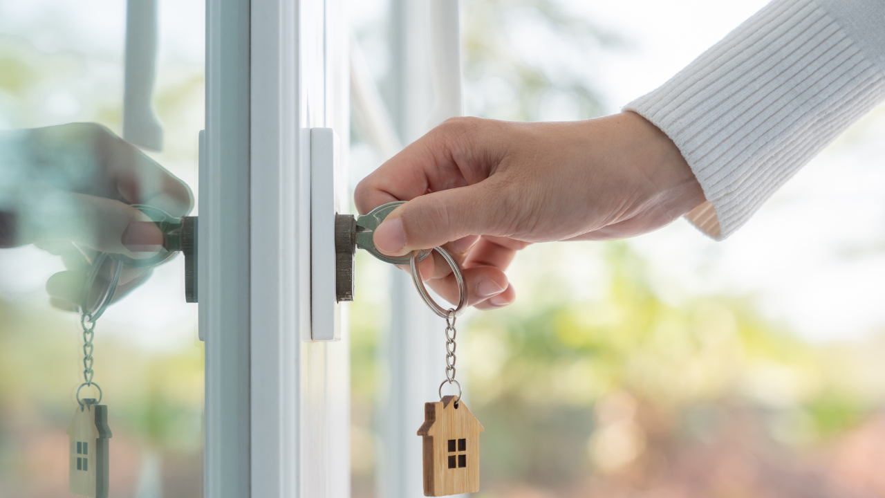 Landlord key for unlocking house is plugged into the door. Second hand house for rent and sale. keychain is blowing in the wind. mortgage for new home, buy, sell, renovate, investment, owner, estate. Image Credit: Adobe Stock Images/Shisu_ka