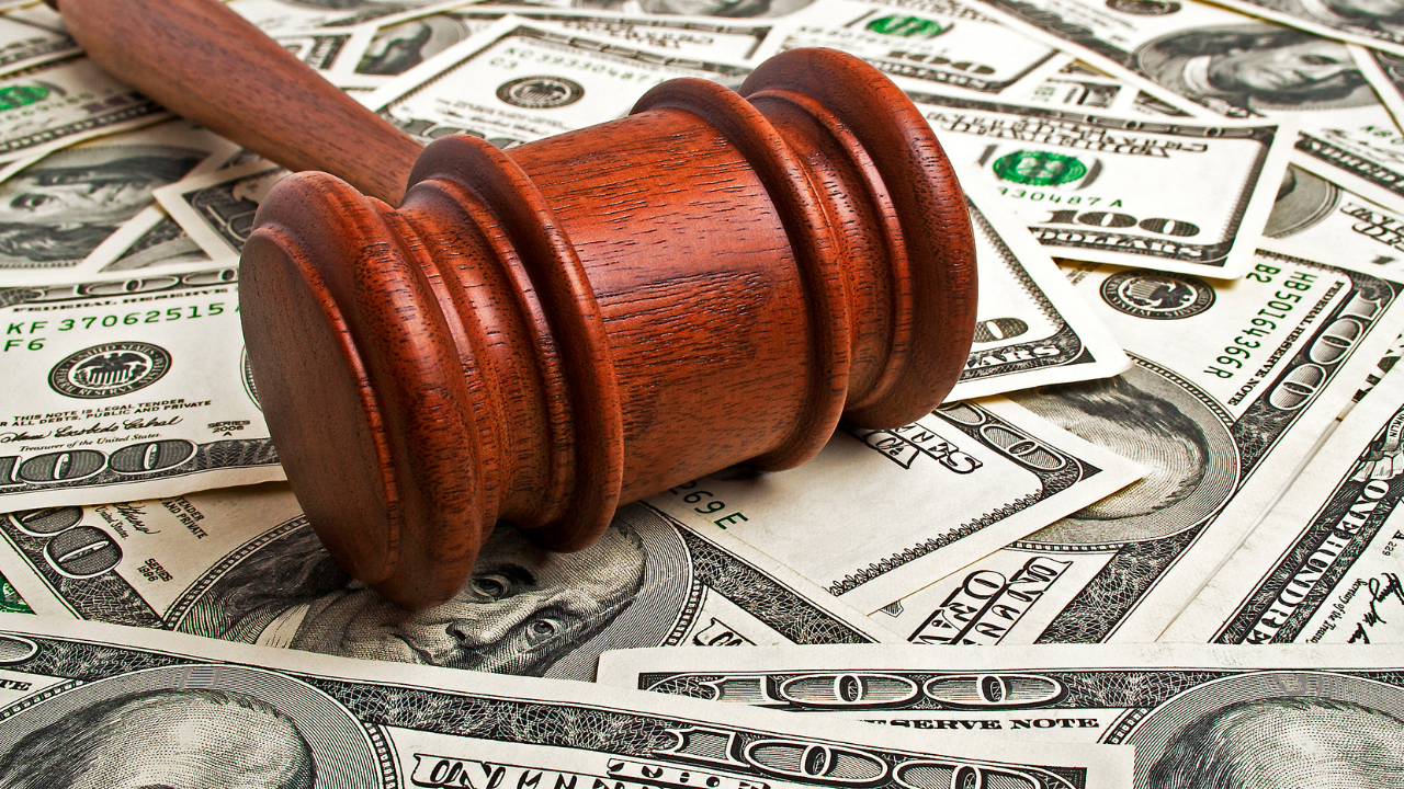 Wooden gavel and American dollars. Image Credit: Adobe Stock Images/domnitsky
