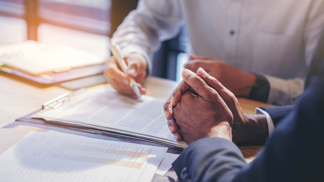 businessman reading documents at meeting, business partner considering contract terms before signing checking legal contract law conditions. Image Credit: Adobe Stock Images/Panumas 