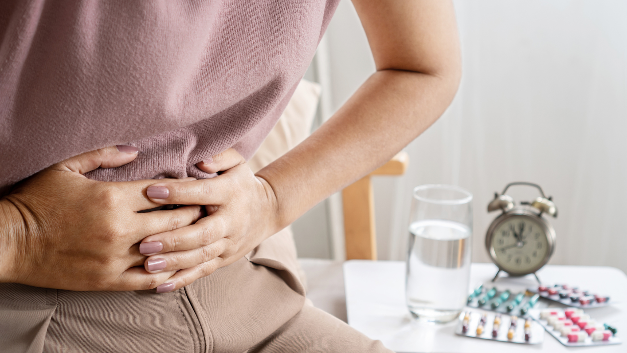 irritable bowel syndrome IBS concept with woman hand holding a stomachache having problems with the digestive system like diarrhea and constipation. Image Credit: Adobe Stock Images/doucefleur 