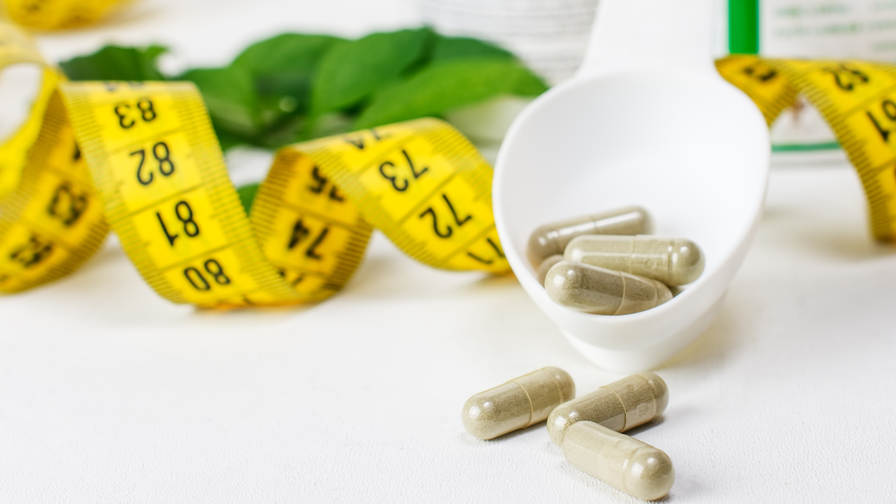 Dietary supplement tablets, measuring tape. Close-up. Image Credit: Adobe Stock Images/Aleksey 159