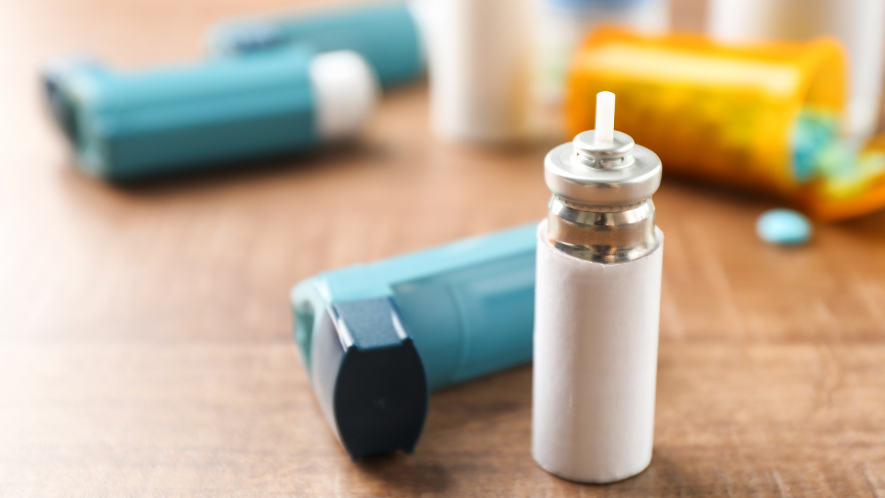 Asthma inhaler with cartridge on wooden table. Image Credit: Adobe Stock Images/Africa Studio