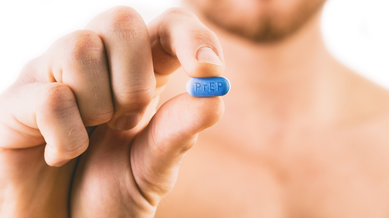 Man holding a pill used for Pre-Exposure Prophylaxis (PrEP) to p. Image Credit: Adobe Stock Images/mbruxelle
