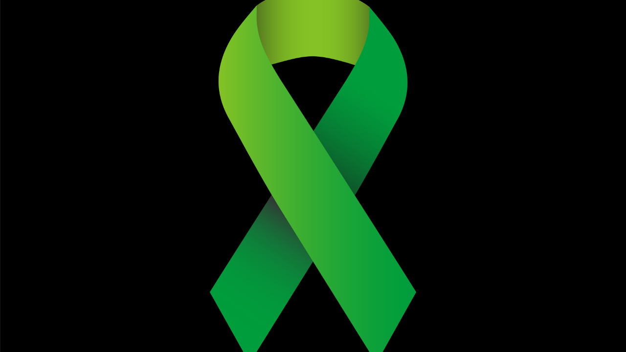 illustration vector graphic of green ribbon Symbolizes concern for eye cancer, depression, missing children, environmental concern, work safety and glaucoma. Image Credit: Adobe Stock Images/Nokers13