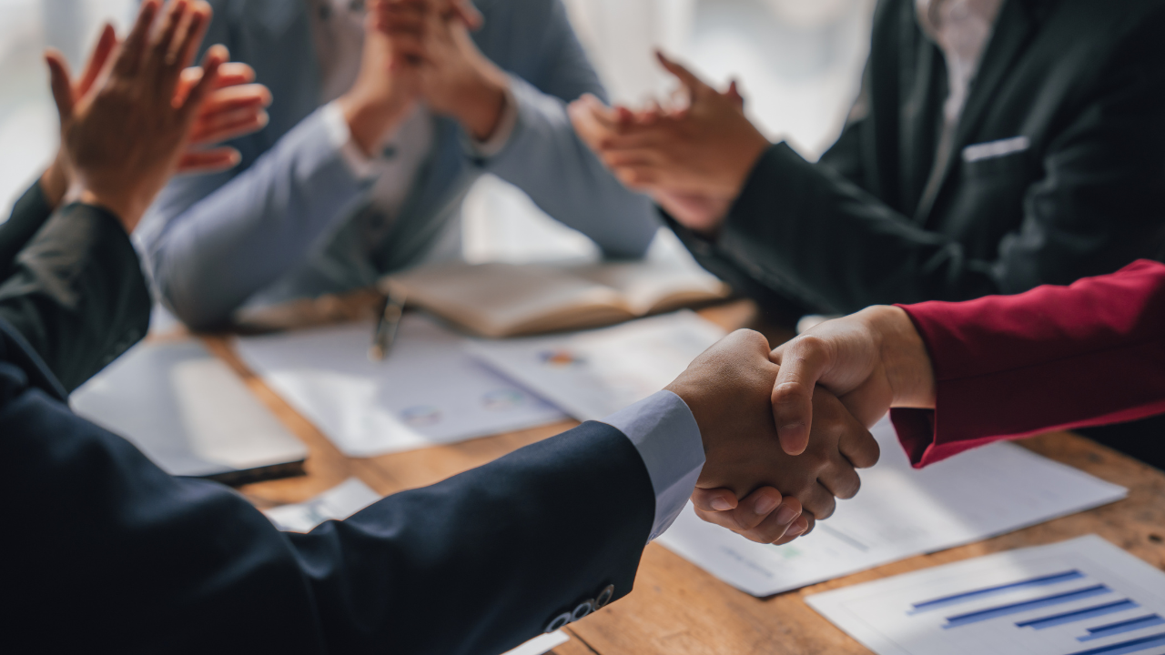 Shaking hands, Team of lawyers and tax auditors brainstorming together and calculating the balance sheet and historical financial accounts of the company and shareholders. Image Credit: Adobe Stock Images/M+Isolation+Photo