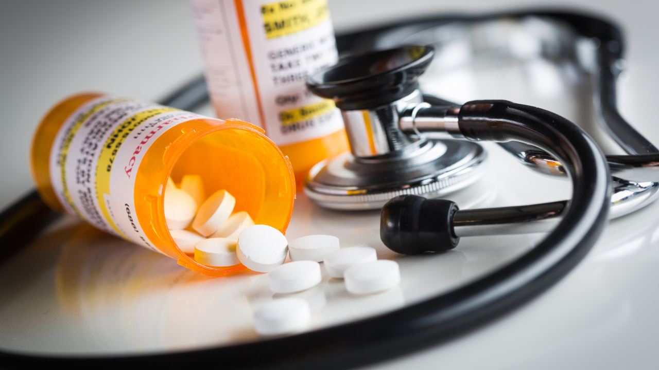 Non-Proprietary Medicine Prescription Bottles and Spilled Pills Abstract with Stethoscope. Image Credit: Adobe Stock Images/Andy Dean