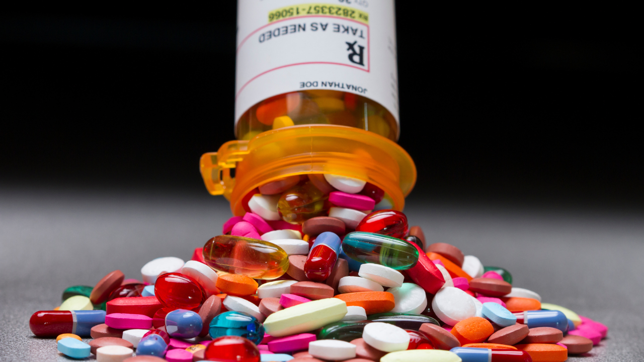 A prescription pill bottle spilling out an assortment of pills. Image Credit: Adobe Stock Images/Burlingham