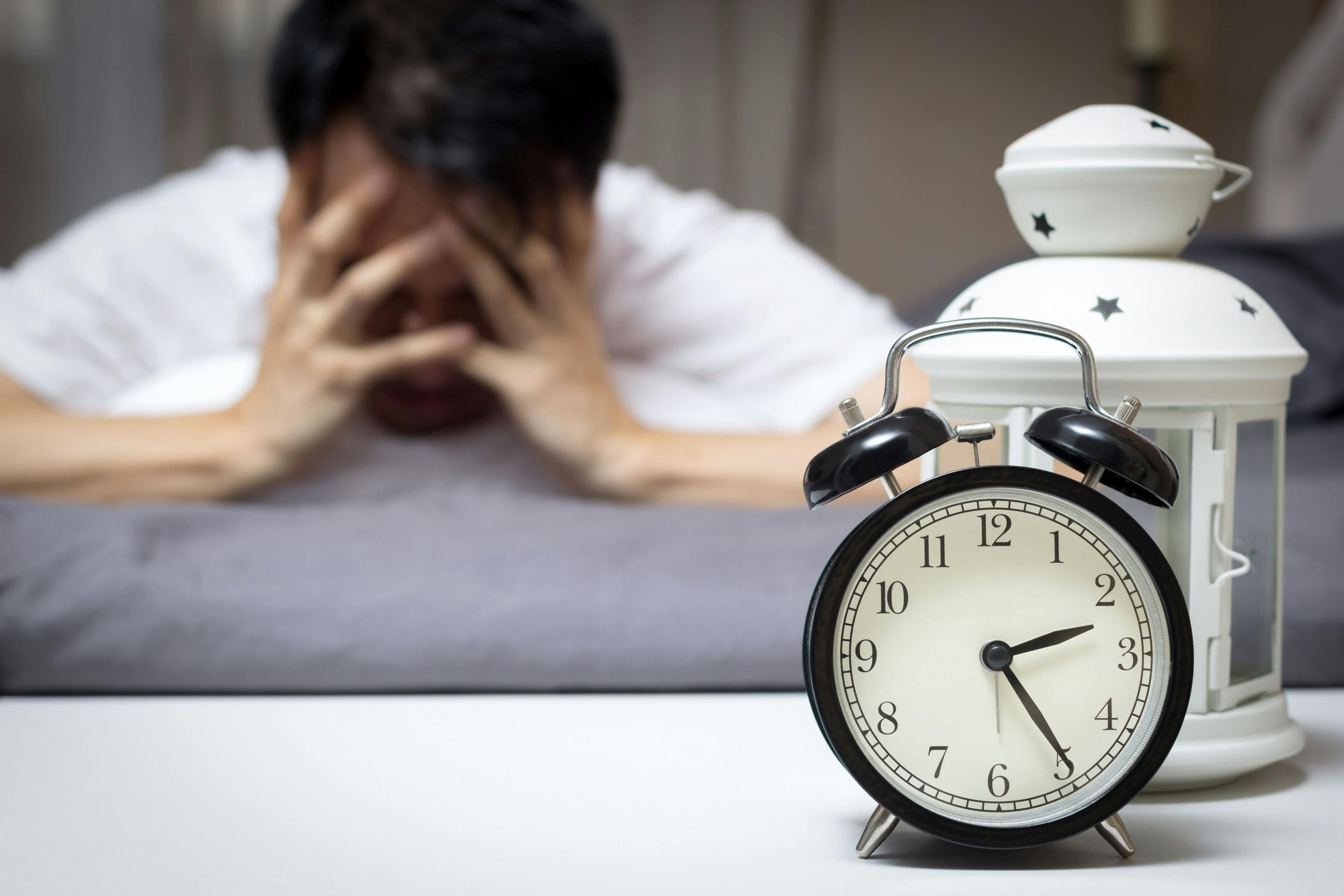 asian man in bed suffering insomnia and sleep disorder thinking about his problem at night. Image Credit: Adobe Stock Images/princeoflove
